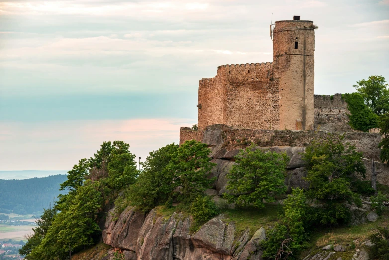 a castle is perched on top of some rocks