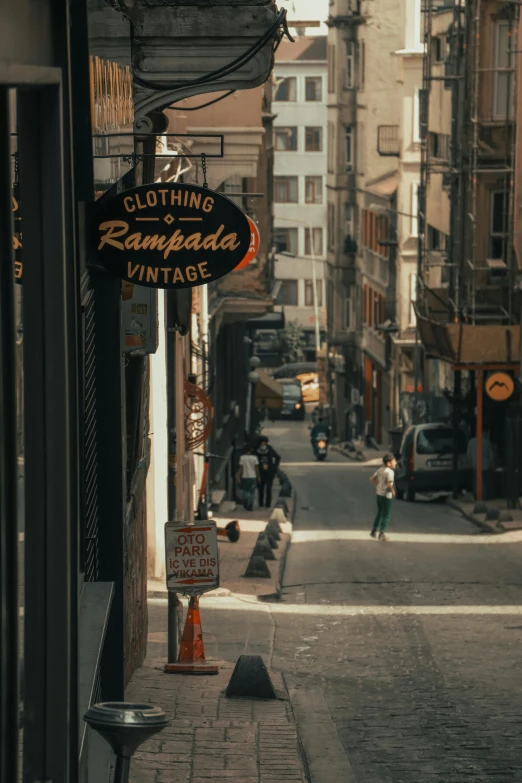 a very narrow street that has some signage on the side