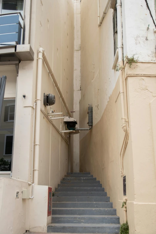 a stairwell with metal railings next to a building