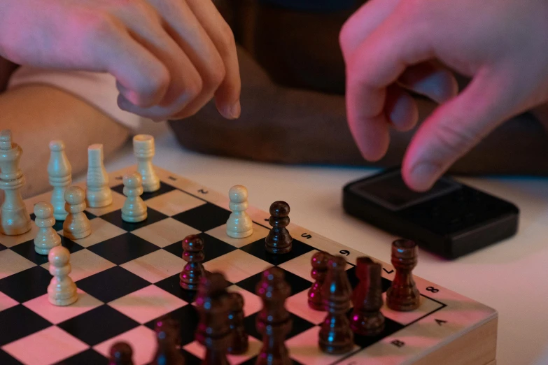 person playing chess at home on their cell phone