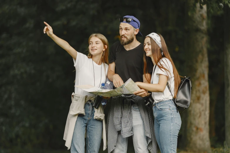 three women standing next to one another pointing towards soing