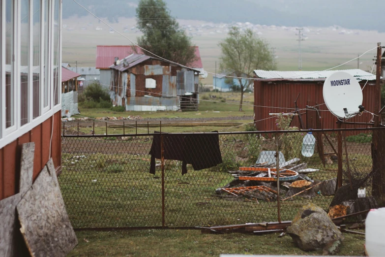 a fence with clothes and other objects on it