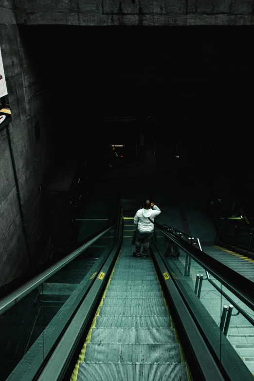 a person on escalator in a large tunnel