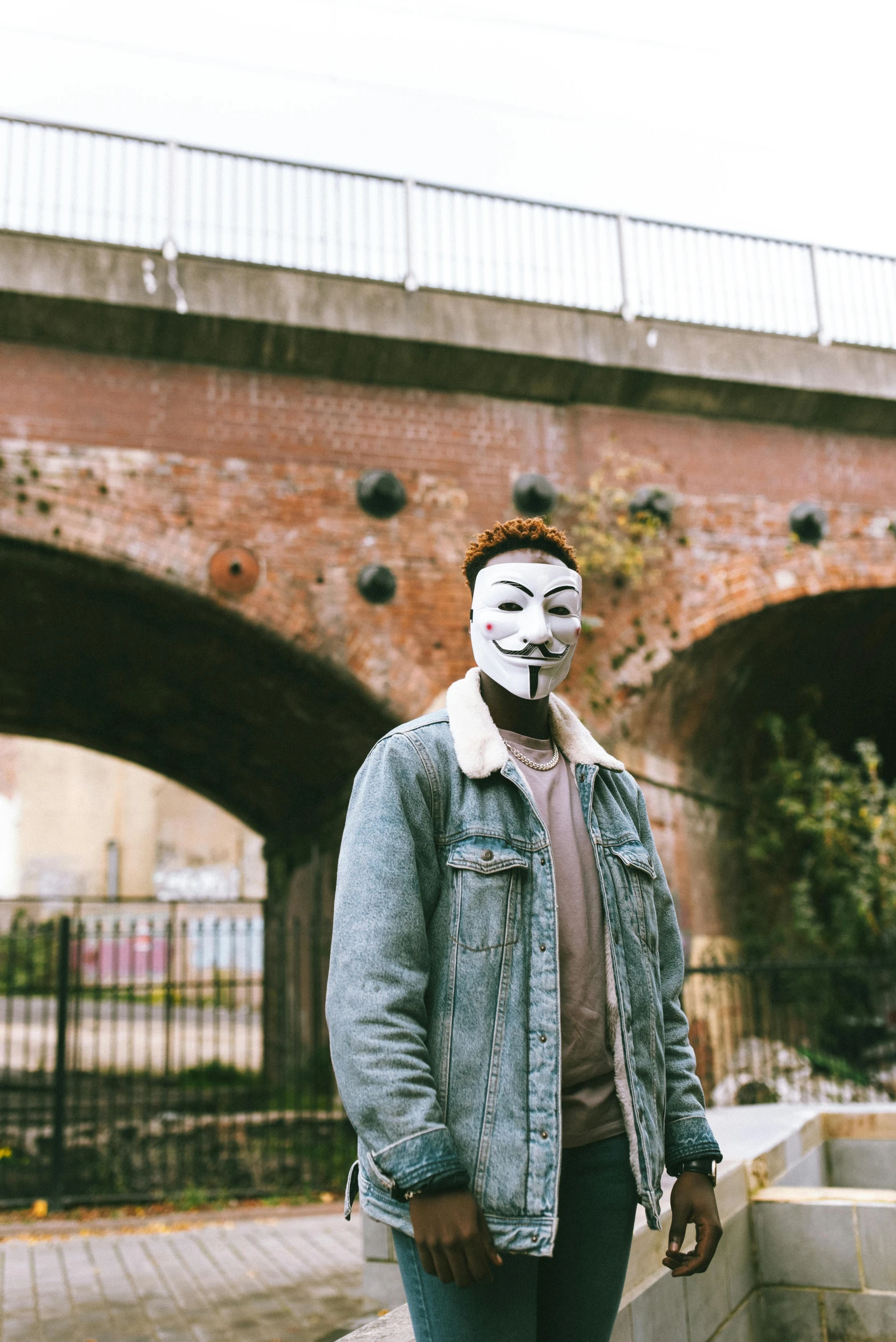 a man with his face painted and his jacket worn over him