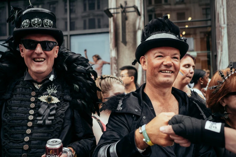 two men standing in the street with other people