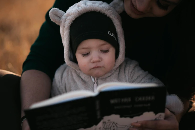 a woman is reading to a small child