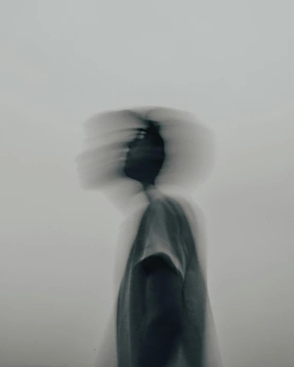 a man standing in the fog while holding a frisbee