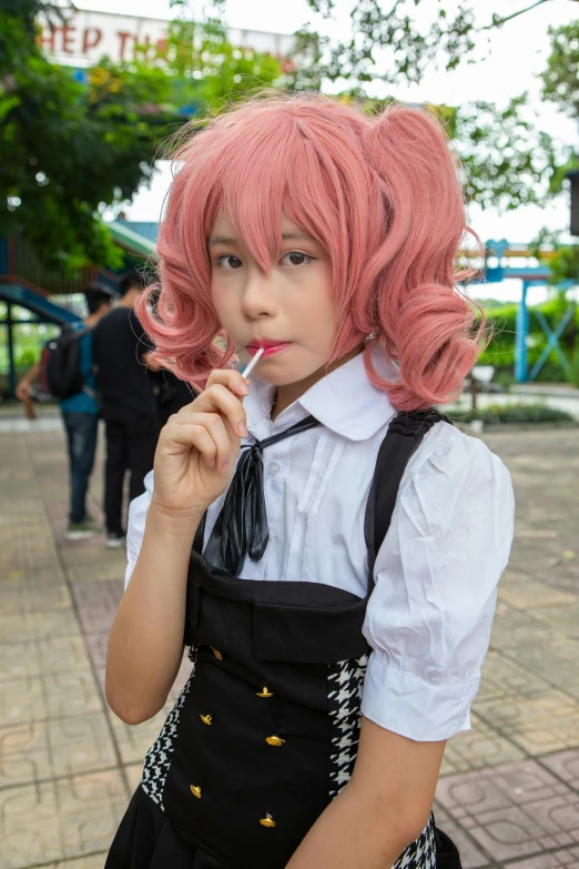 a little girl with pink hair wearing aprons