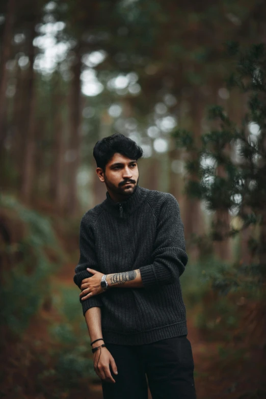 a man standing in the middle of a forest