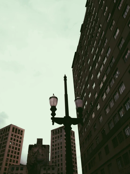 a light post in the city with large buildings