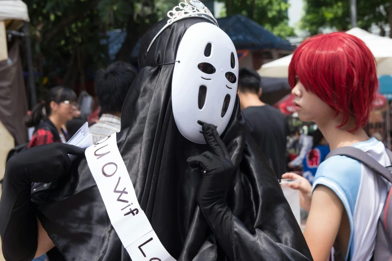 a woman with red hair and red locks wearing a mask