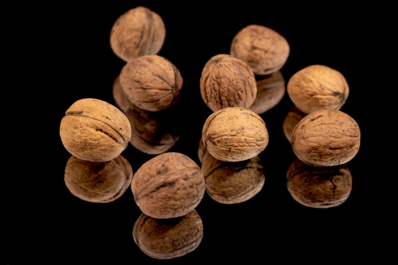 several nuts with some reflected on a surface