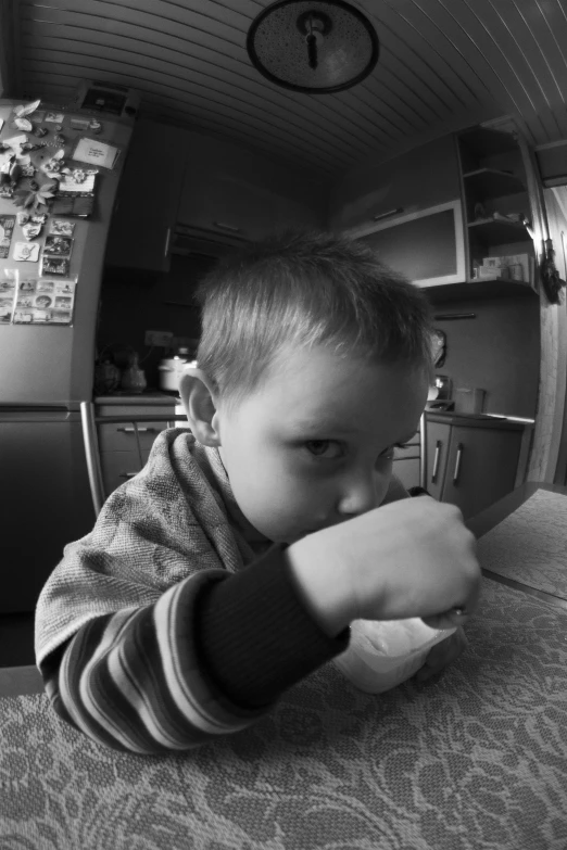 a  sitting at the table eating food