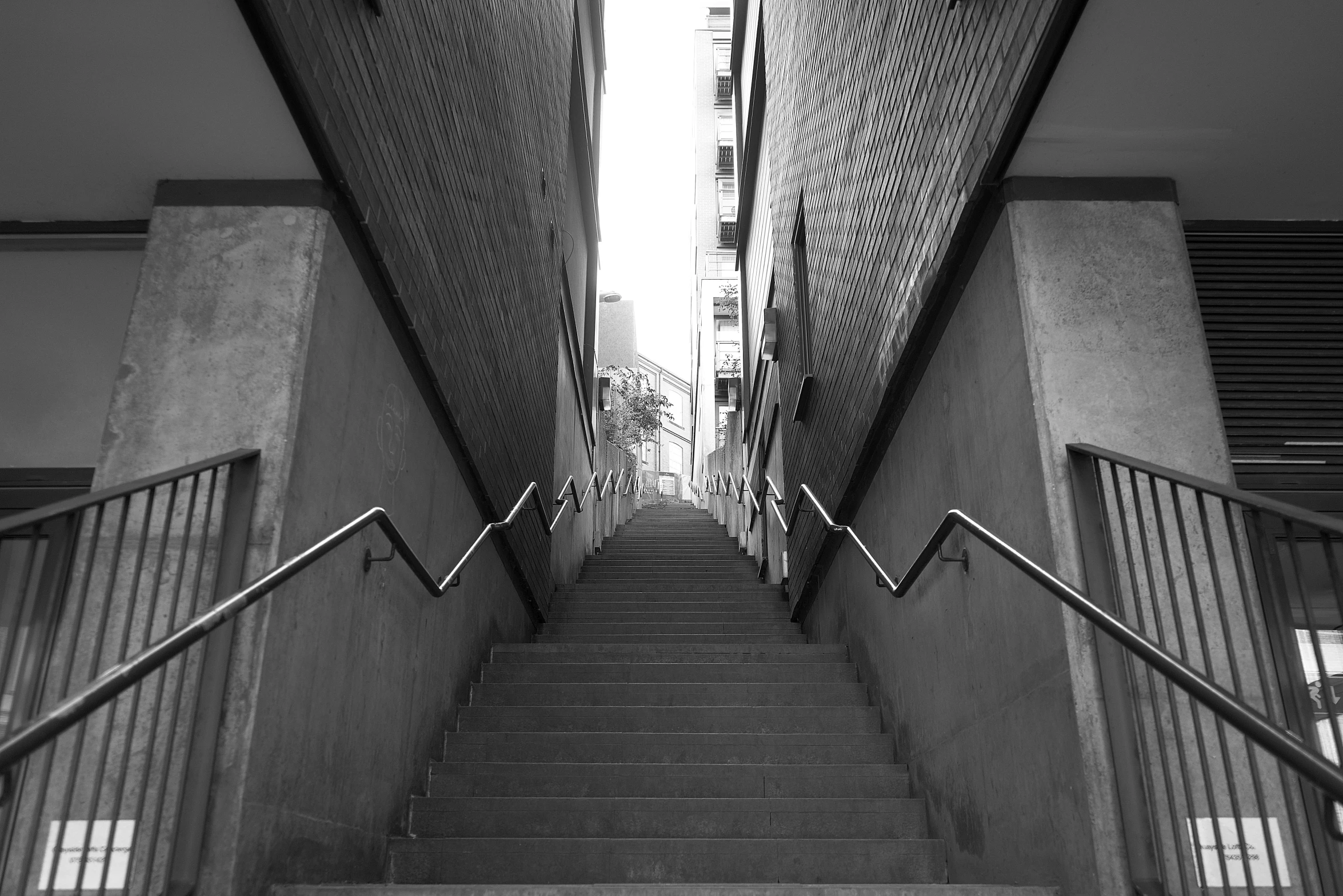 a staircase leading down to a tall building