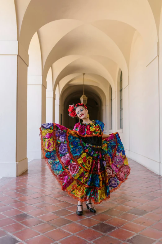 a woman in traditional mexican clothes posing for a po