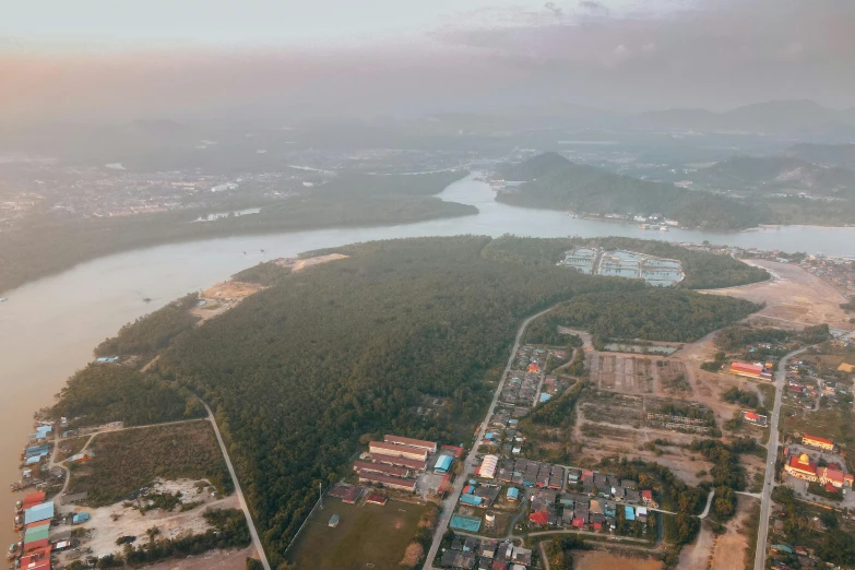 an aerial view of several industrial buildings along a river