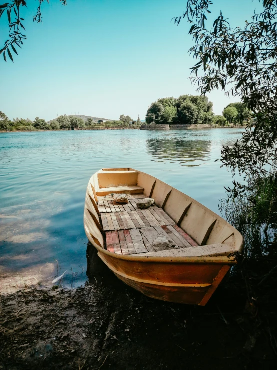 an empty boat that is on the shore