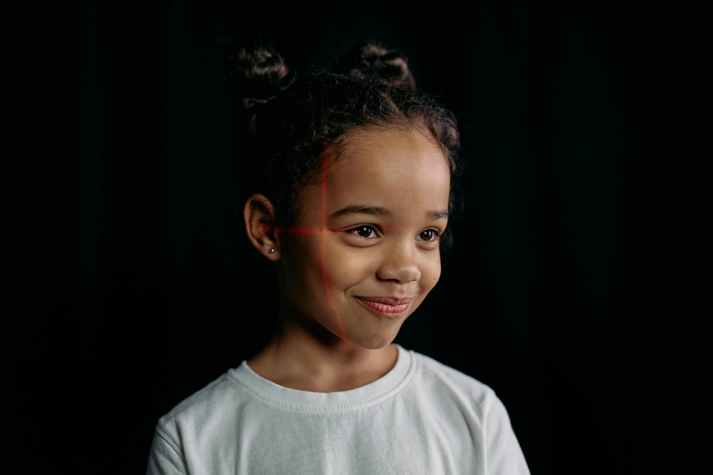 an attractive little girl standing with one hand on her head