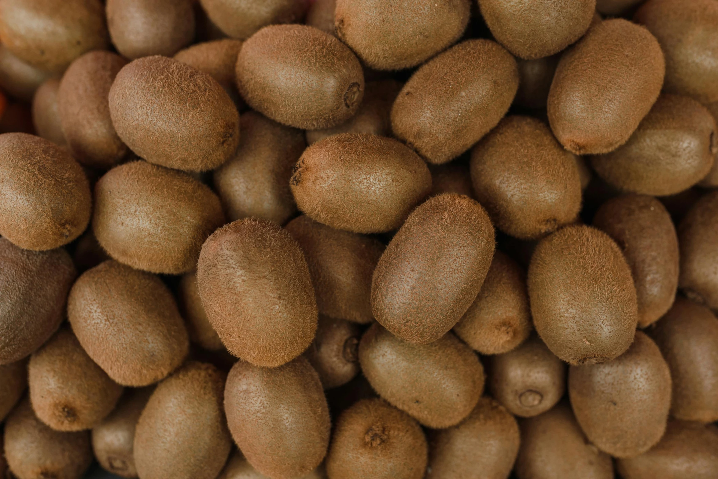 several kiwis are piled on top of each other