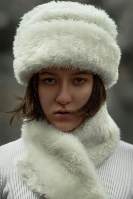 a young woman with an unusual hat and scarf