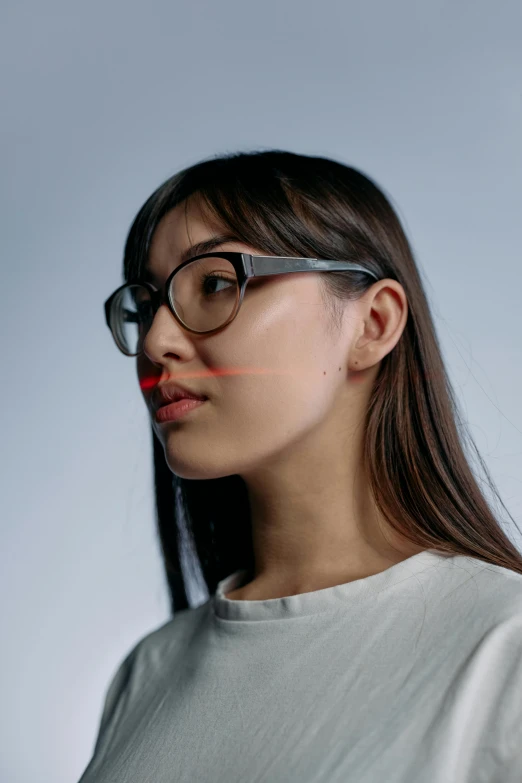 a girl wearing glasses with the shape of a erfly painted on her face