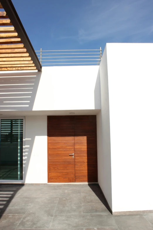 a white building with wood doors and windows