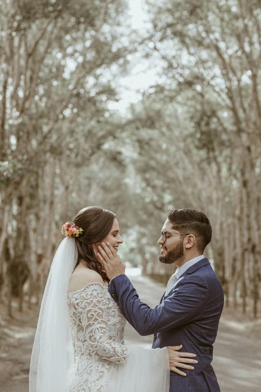 a woman standing next to a man wearing a suit