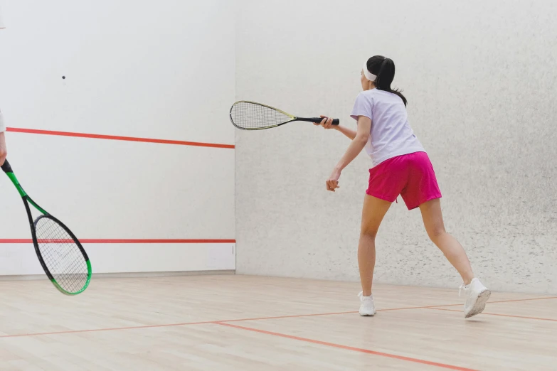 a woman is holding her tennis racket out