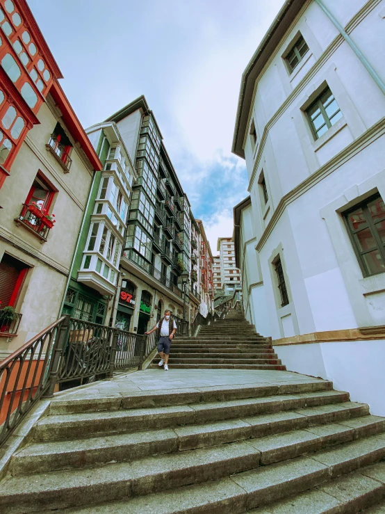 the steps are made of concrete and the buildings have red windows on them