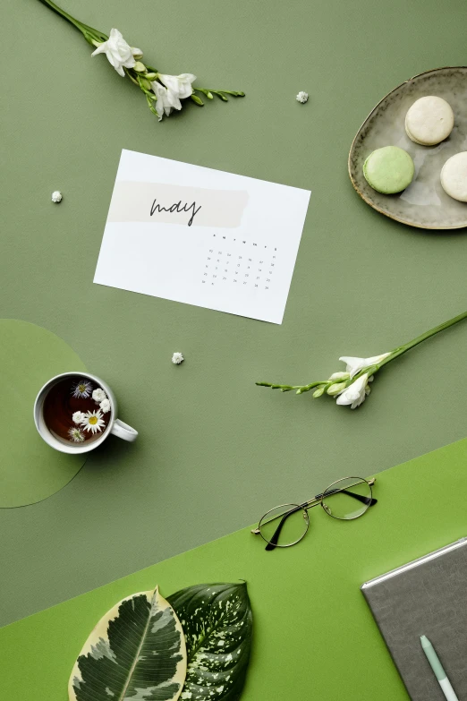 a plate with three cookies, two flowers and two leaves on it