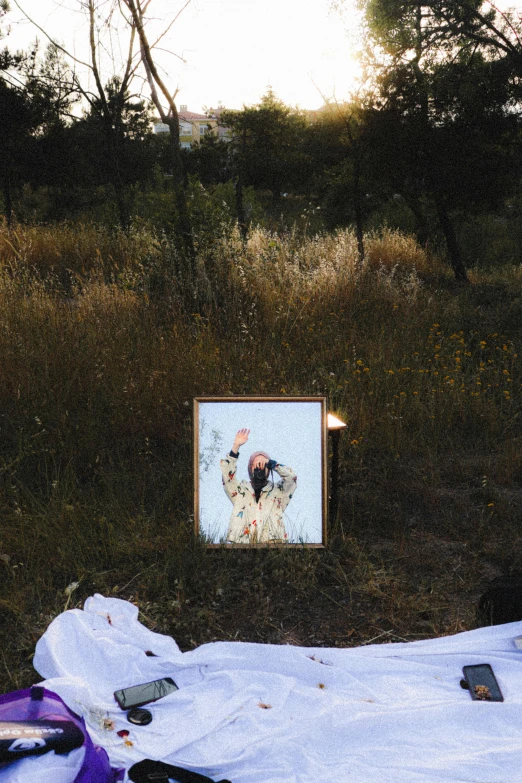 an outdoor memorial on a blanket near some trees