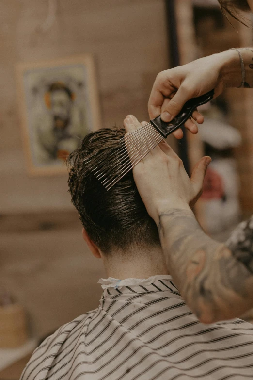 a person getting their hair cut at a barber shop