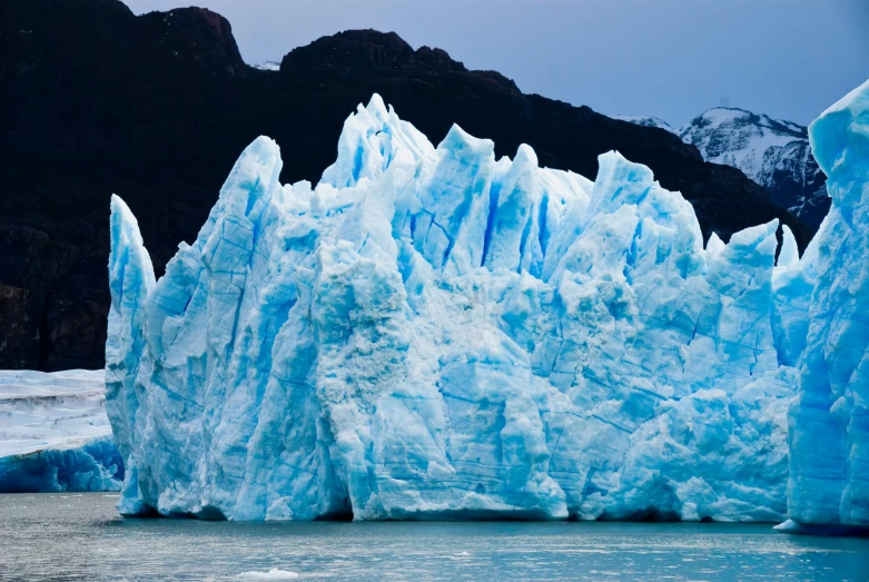 a large iceberg that is very large with huge rocks