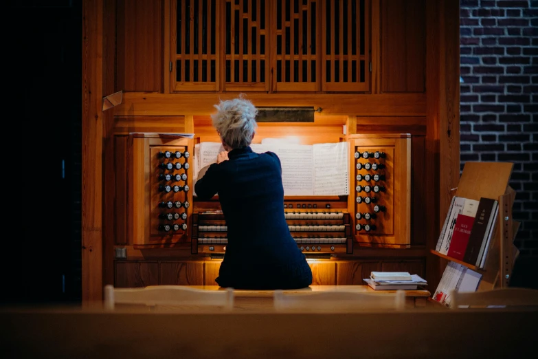 a woman is looking at a computer organ