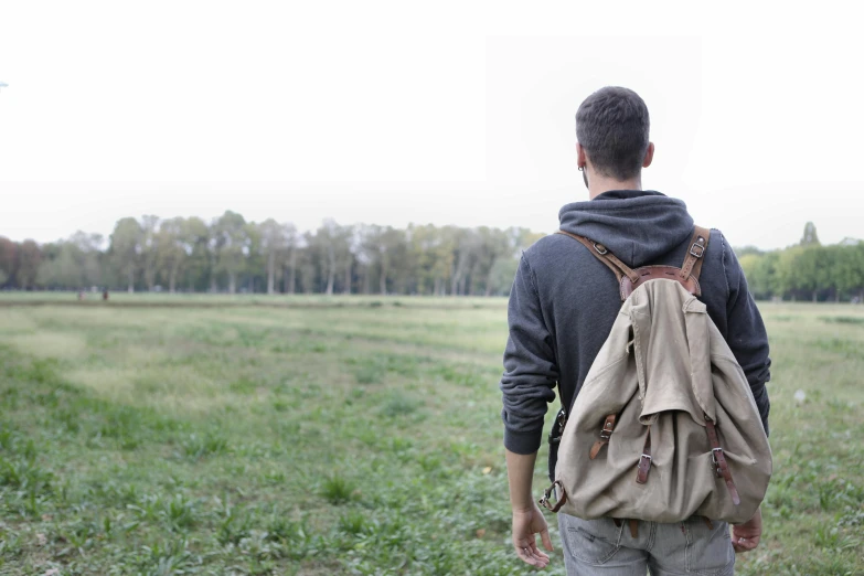 man with a backpack on walking away from the camera