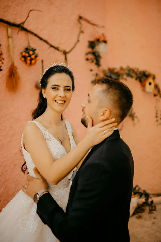 a smiling woman hugs the groom at his wedding