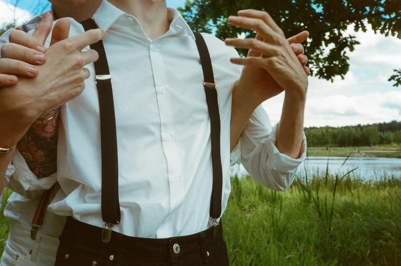 a man wearing suspenders posing for a picture