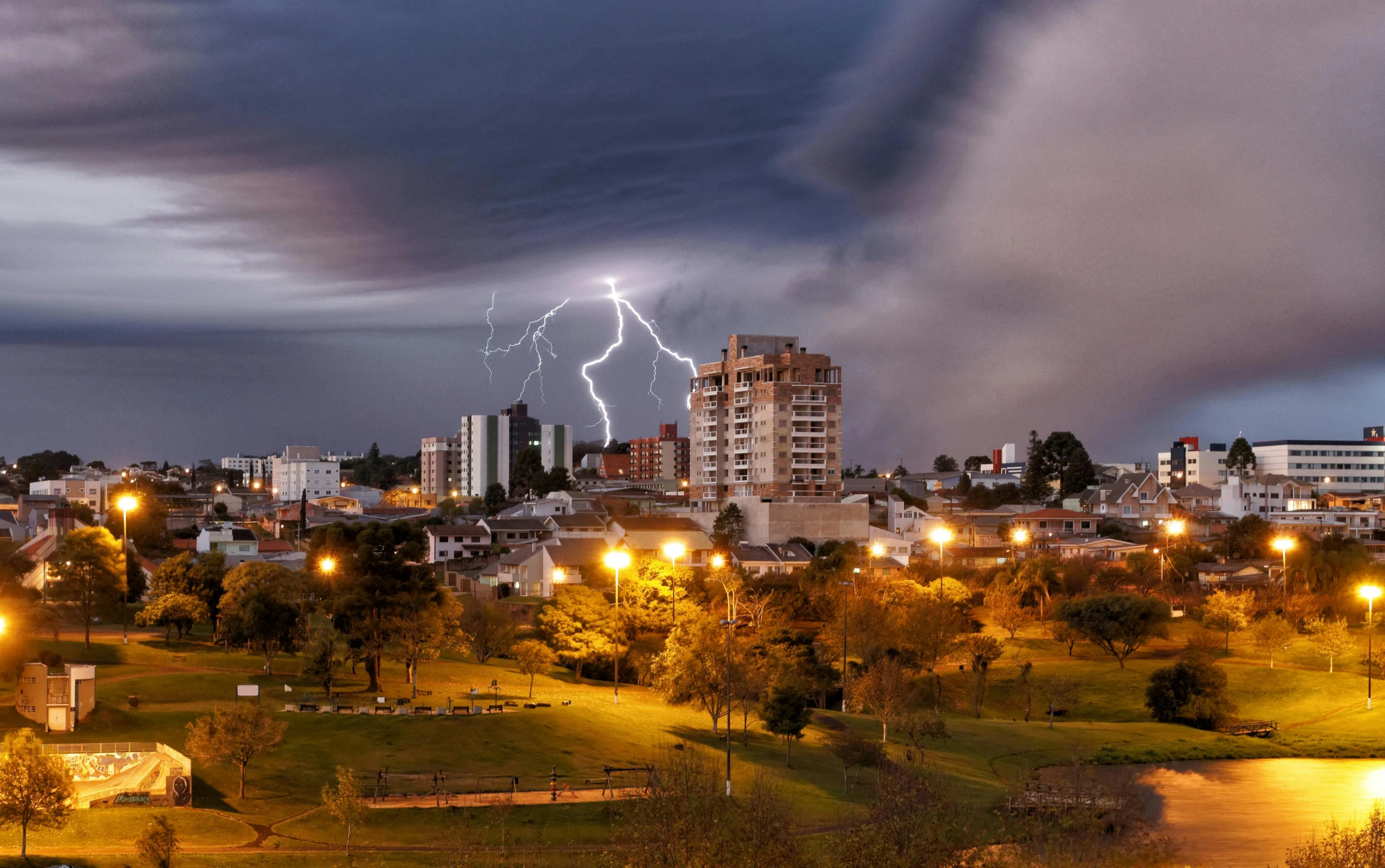 lightning over a city during a rain storm