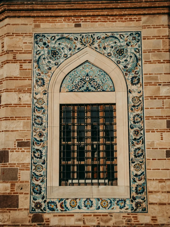 the window has a stained glass covering and decorative window pane