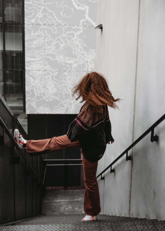 the  is climbing the stairwell of her house