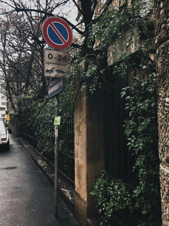 street signs and a van parked on a side walk