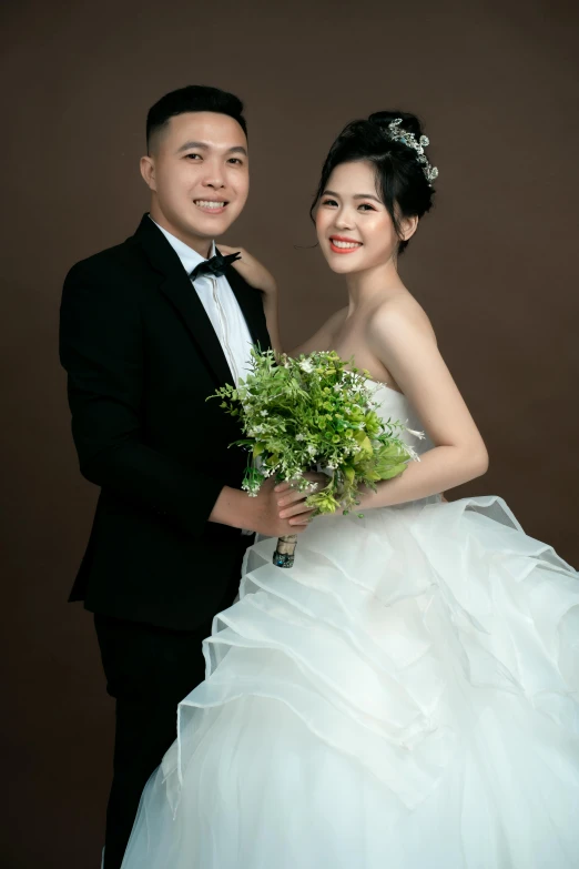 a man and woman posing in wedding outfits