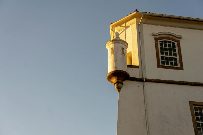 the front of a very tall tower with a clock on it's side