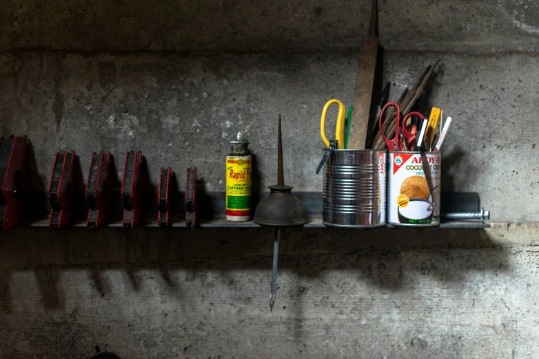 many different items in a metal container on a shelf