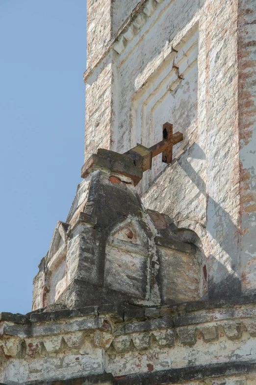 an old church steeple with a crucifix on top