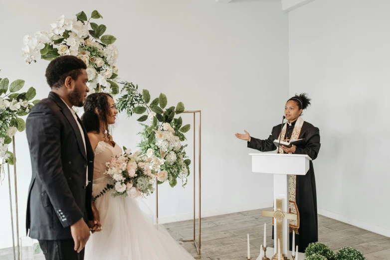 a couple in formal clothes are having their wedding vows