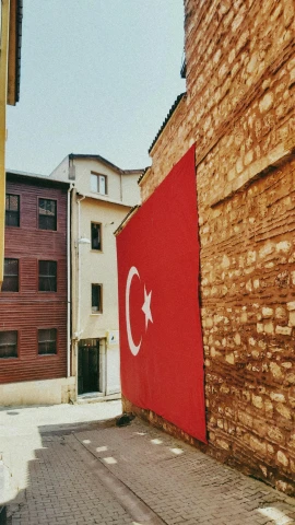 there is a flag of turkey next to some buildings