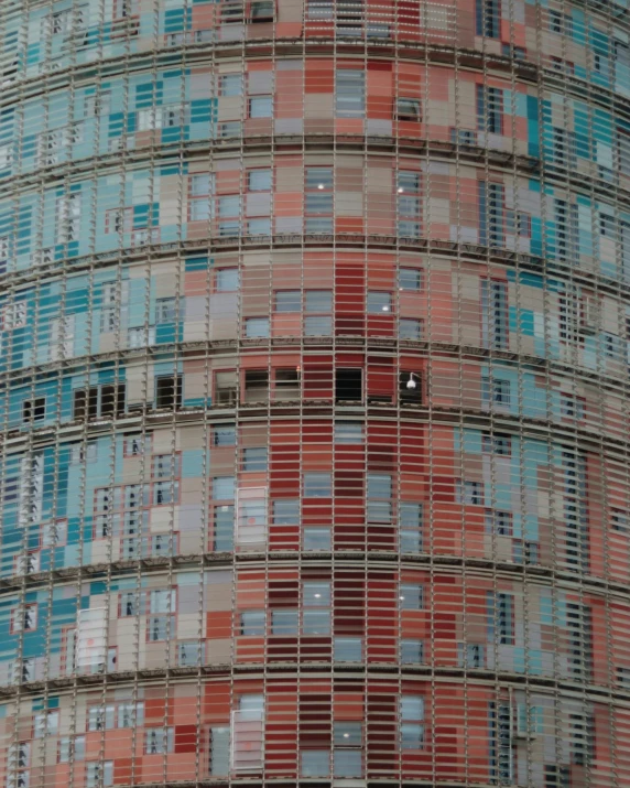 an image of a red and blue building with the top half covered by blue bricks