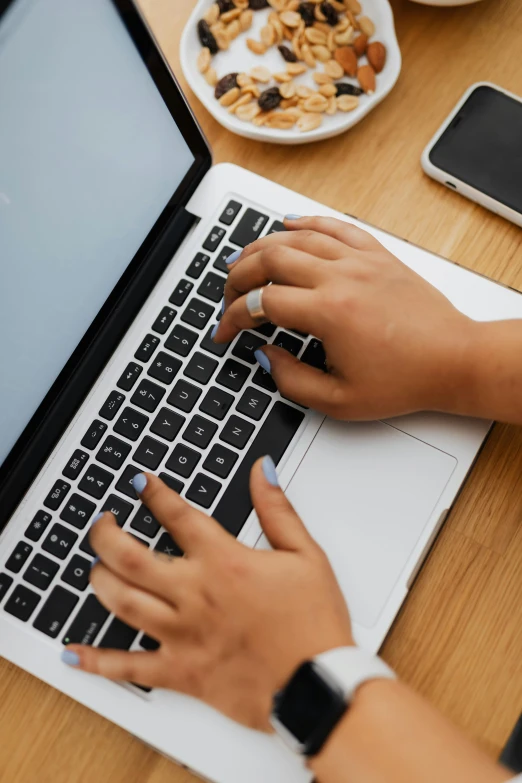 two hands on the keyboard of a laptop