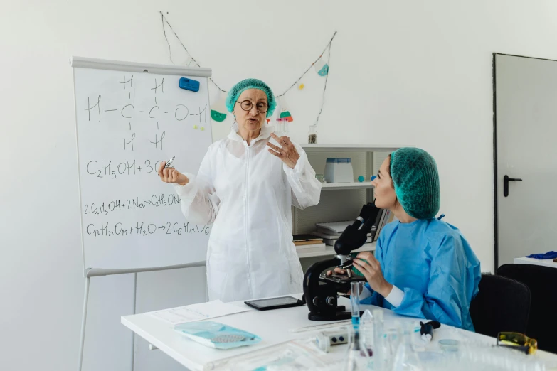 a doctor in scrubs speaking to a colleague